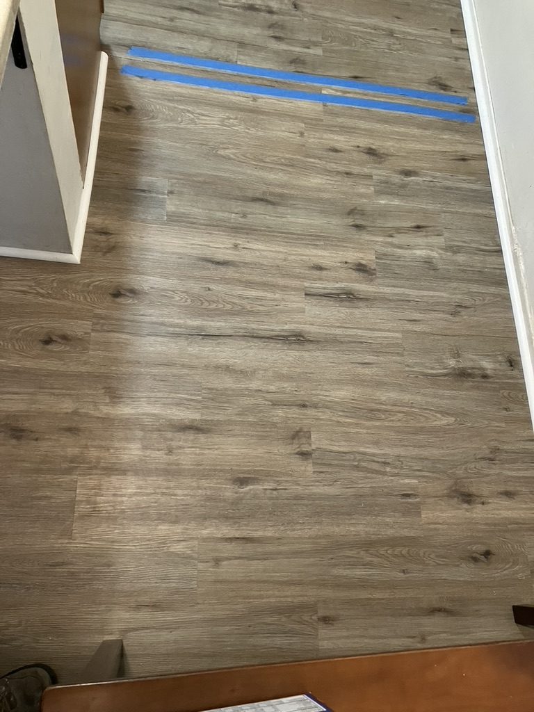 Flooring after patch — wood-look planks blended in