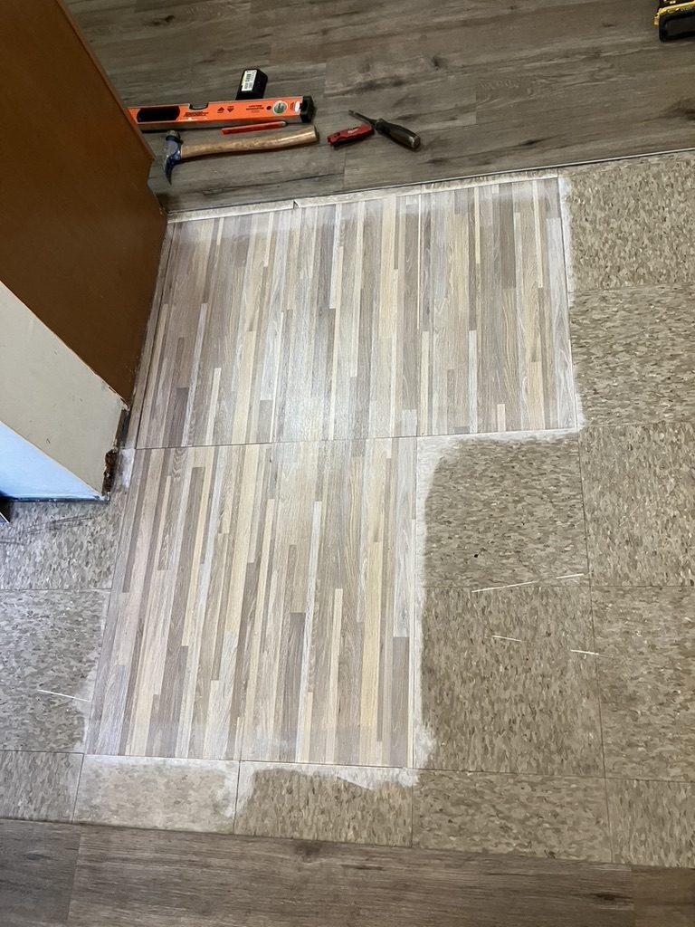 Flooring before patch — damaged section opened for repair