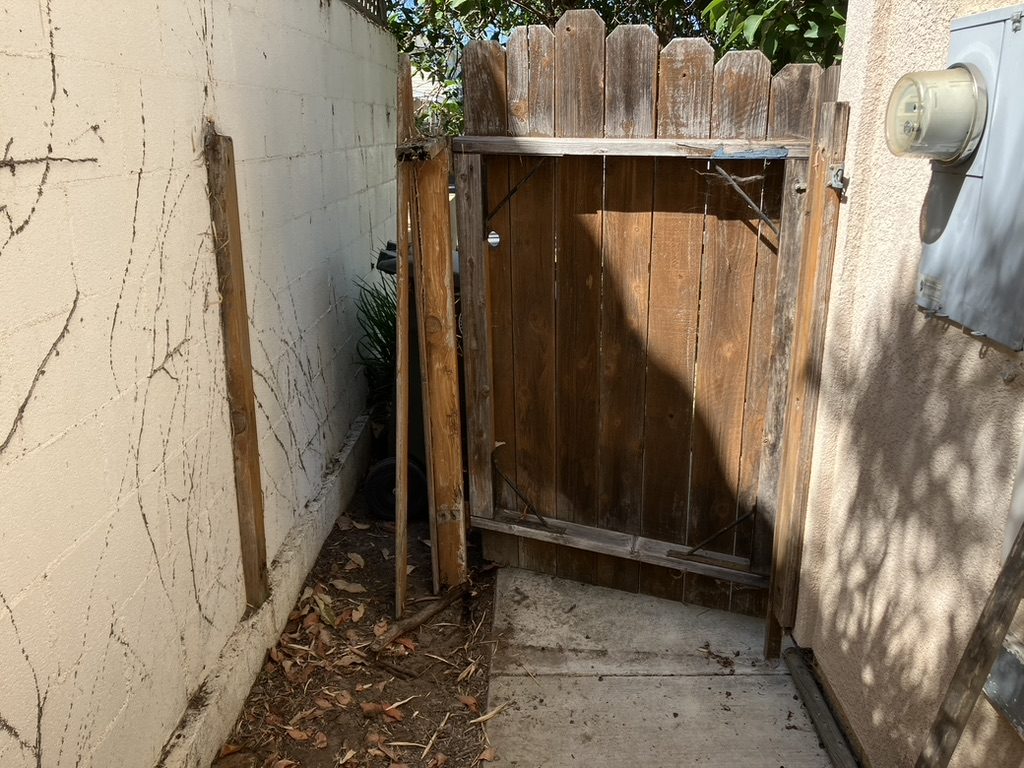Broken weathered side gate before repair