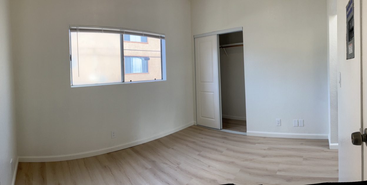 Bedroom after remodel — new flooring, paint, and trim